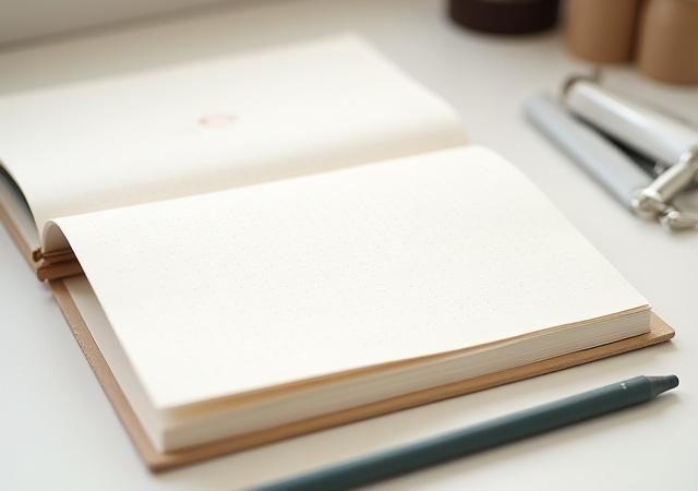 Open artist's sketchbook with custom letterpress cover and dot-grid pages